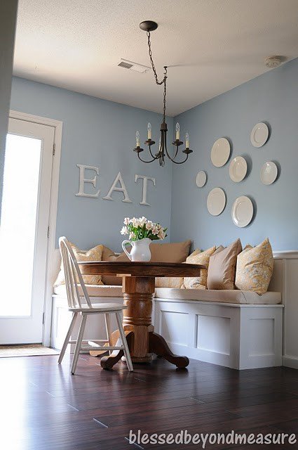 white cream blue dining room banquette padded kitchen bench plate display chandelier Via 29 Rue House