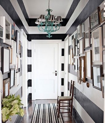 monochrome black and white stripe painted hallway picture gallery turquoise light runner Via The Aestate